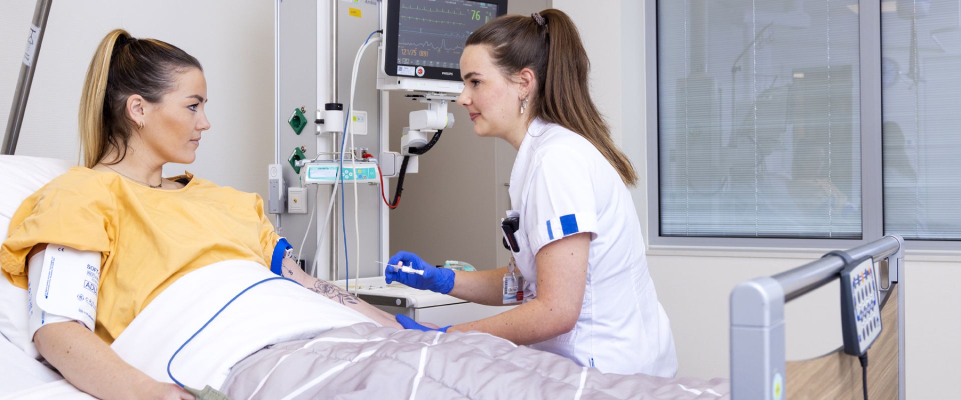 Patiënt krijgt een infuus aangebracht door een verpleegkundige