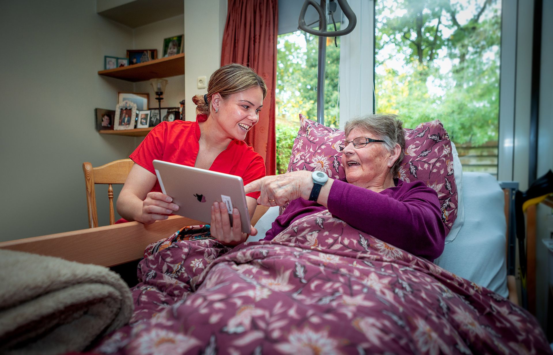 Medewerker en cliënt kijken op tablet