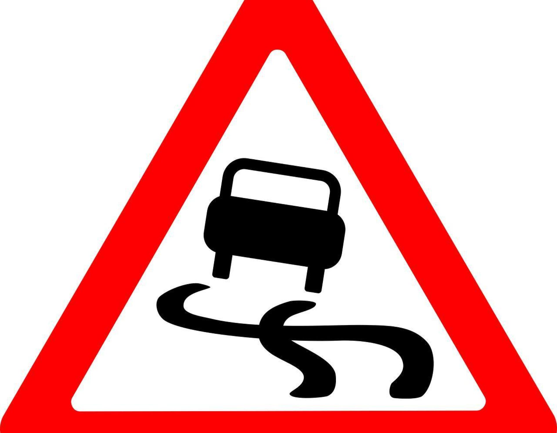 Bord dat aangeeft dat het glad is om de weg